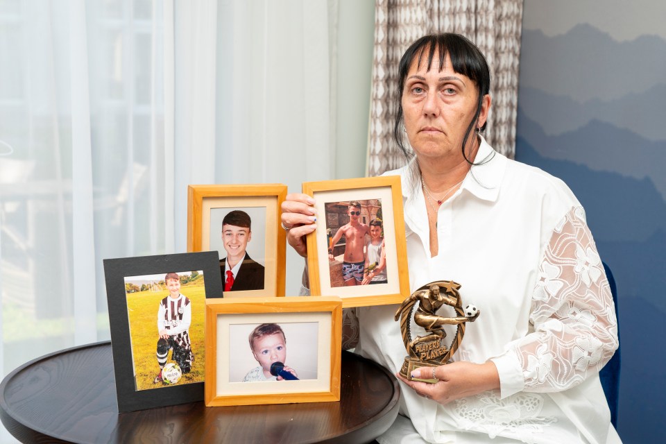 a woman is holding a trophy that says soccer player of the year