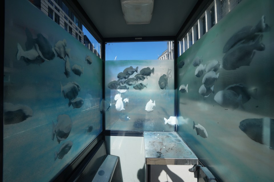 a room with a painting of fish on the wall