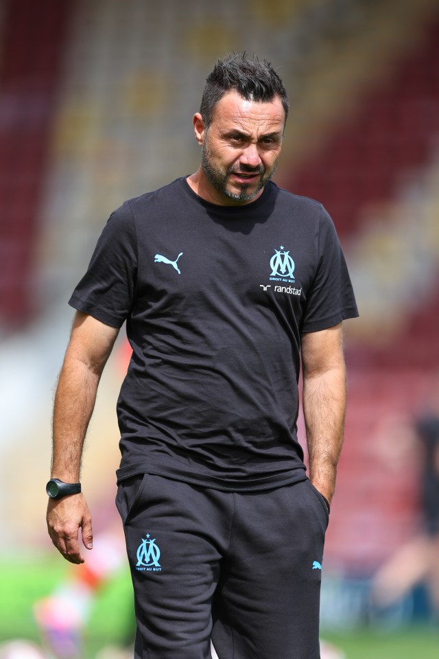 a man wearing a t-shirt that says ' olympique marseille ' on it