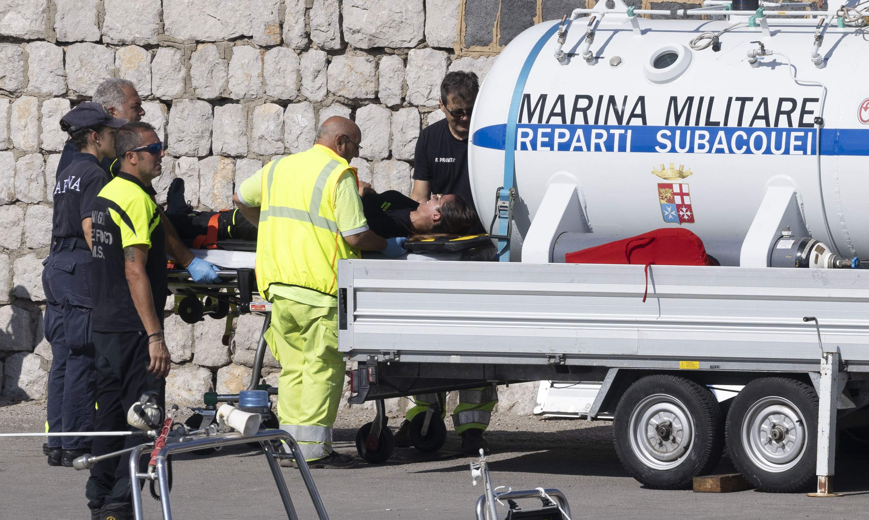 Dive rescue teams using a decompression chamber to recover after searching the wreck