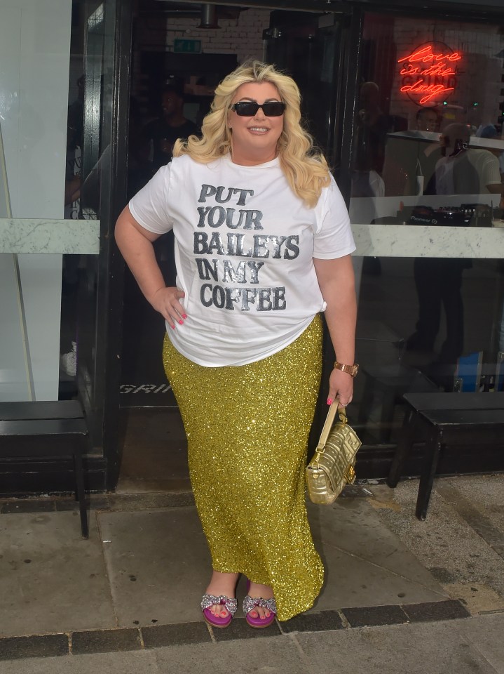 a woman wearing a white shirt that says put your baileys in my coffee