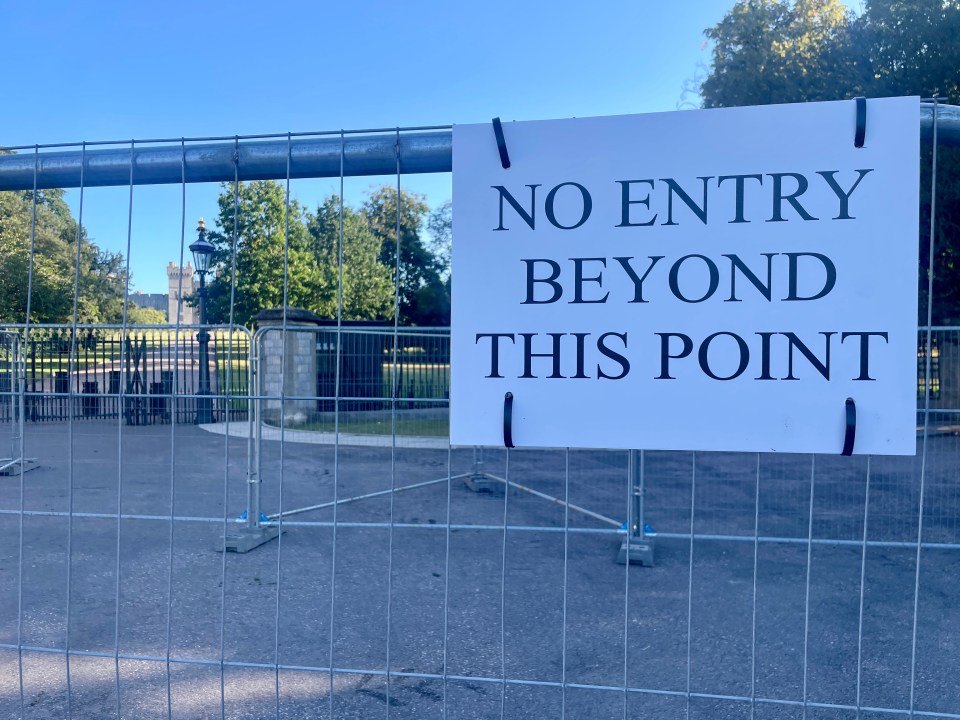 a sign on a fence says no entry beyond this point
