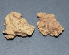 two small rocks are sitting next to each other on a table