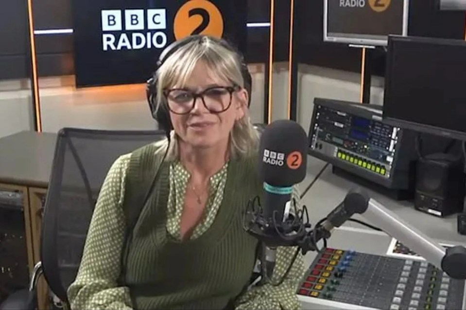 a woman is sitting in front of a microphone in a radio studio .