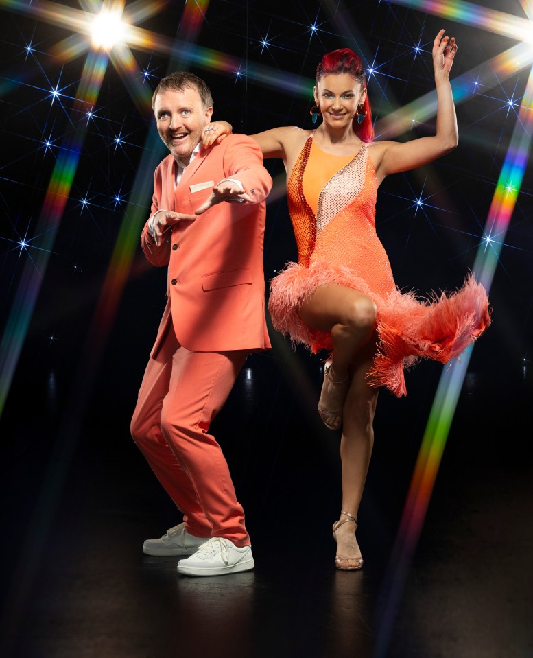 a man and a woman are dancing on a stage