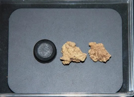 two pieces of gold next to an oreo cookie