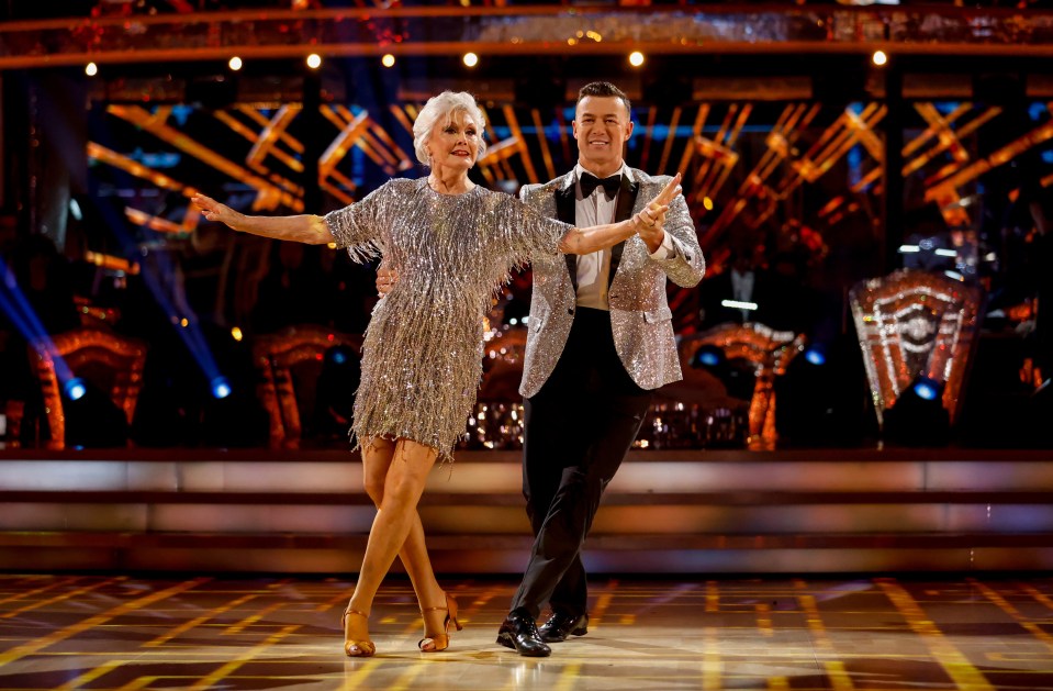 a man and a woman are dancing on a stage
