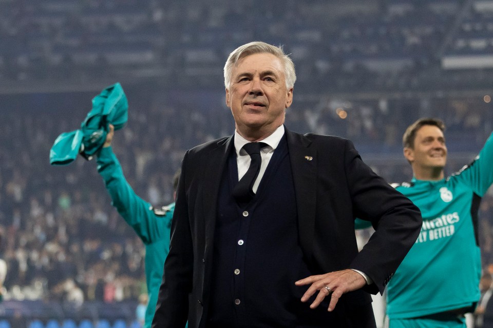 a man in a suit and tie stands on a soccer field