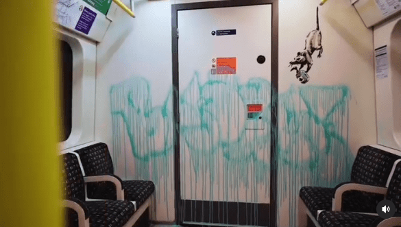a subway car with graffiti on the wall and a door