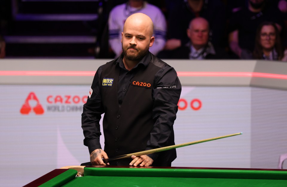 a man in a cazoo shirt holds a cue on a pool table