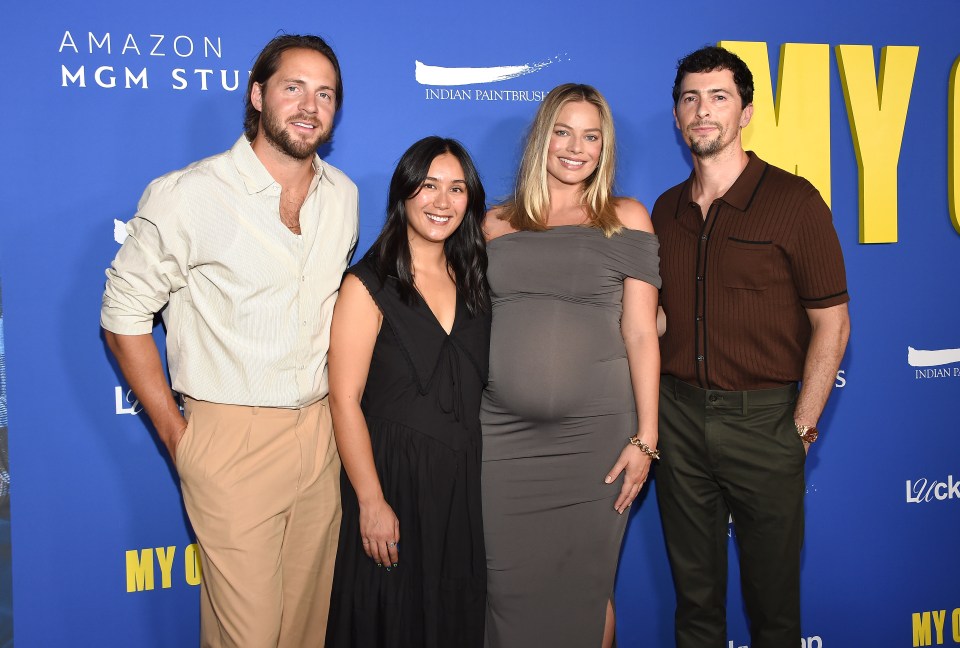 a group of people standing on a blue carpet that says amazon mgm stu