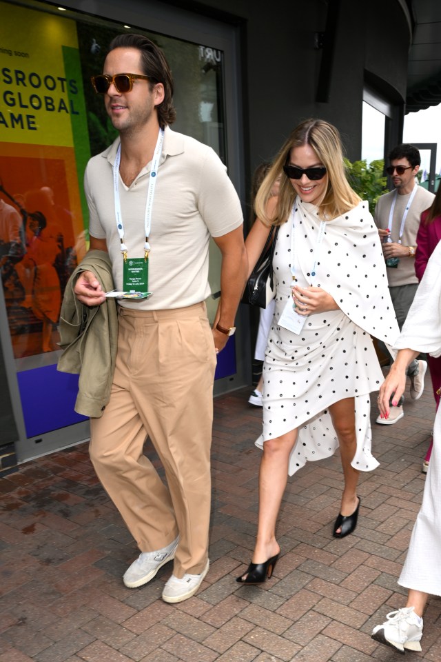 a man wearing a lanyard that says ' sroots global game ' on it