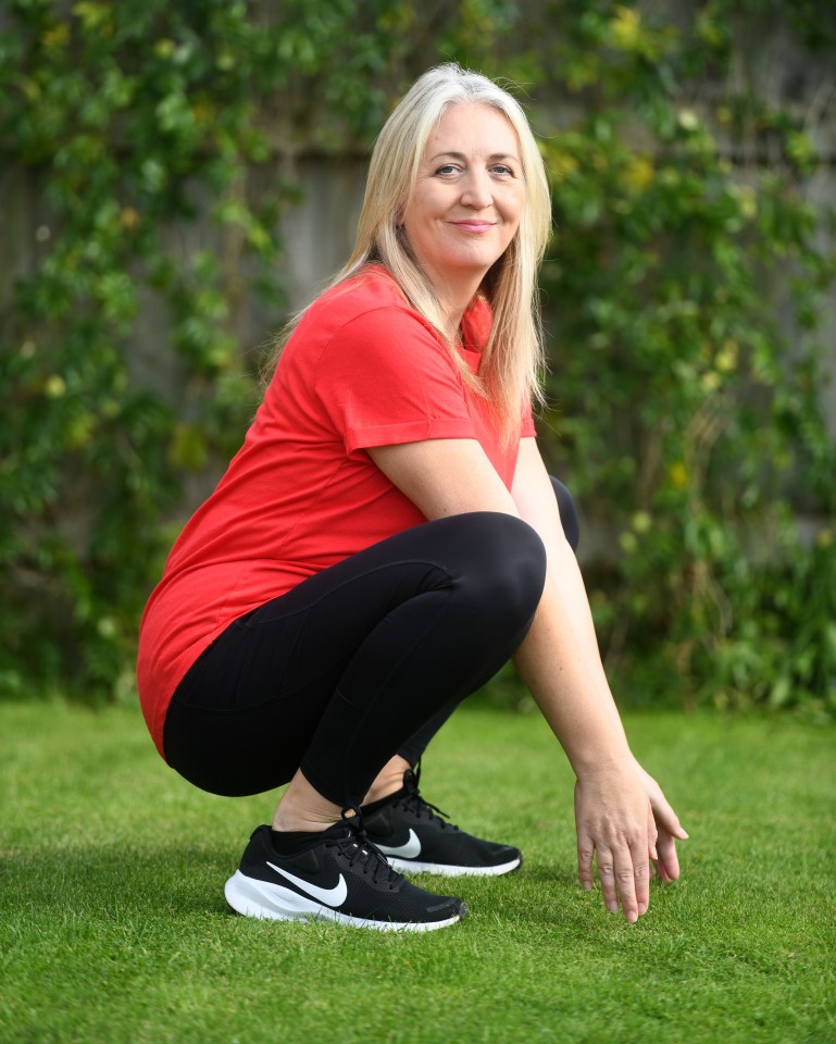 a woman squatting on the grass wearing nike shoes