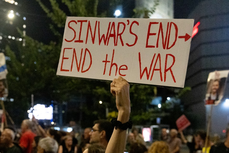 A protester holds a sign during a demonstration calling for an hostages deal in Tel Aviv on Thursday