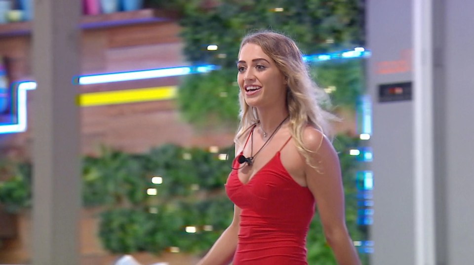 a woman in a red dress with a microphone on her neck