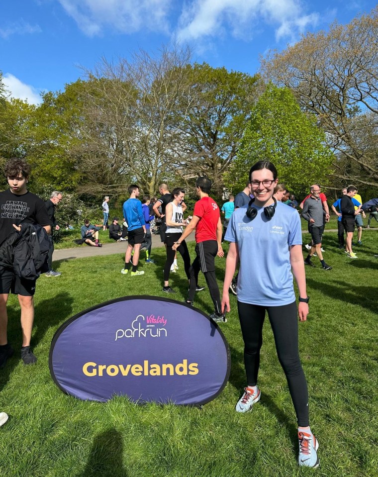a woman stands in front of a sign that says grovelands