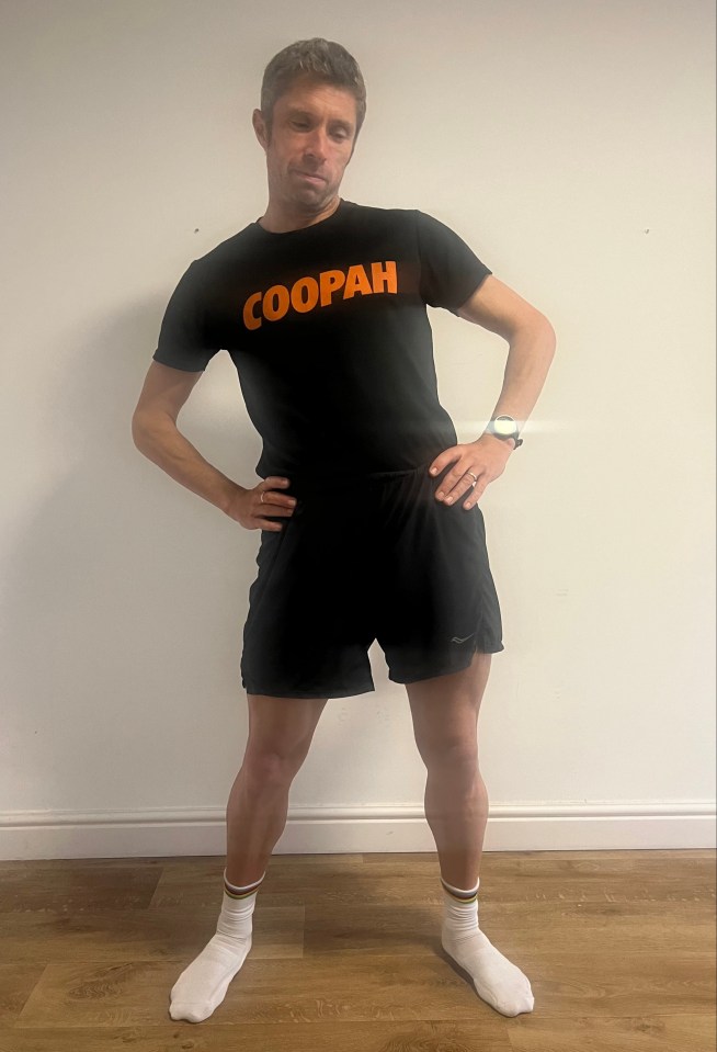 a man wearing a black shirt that says coopah