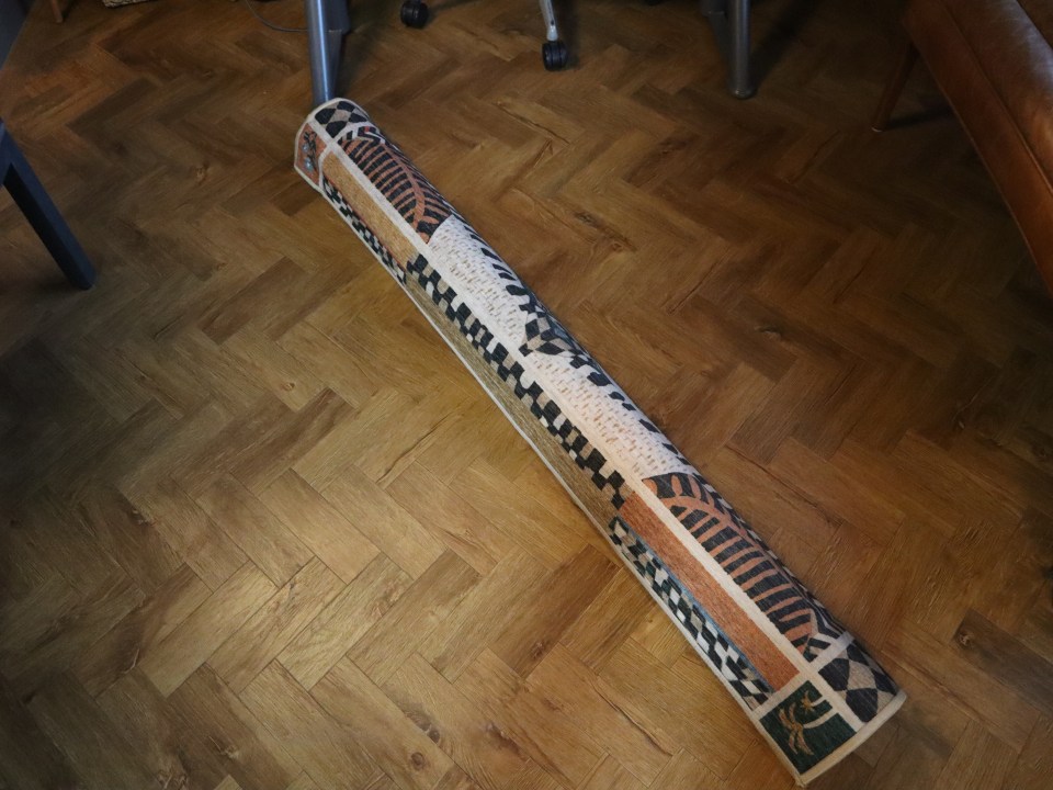 a rug is rolled up on a wooden floor