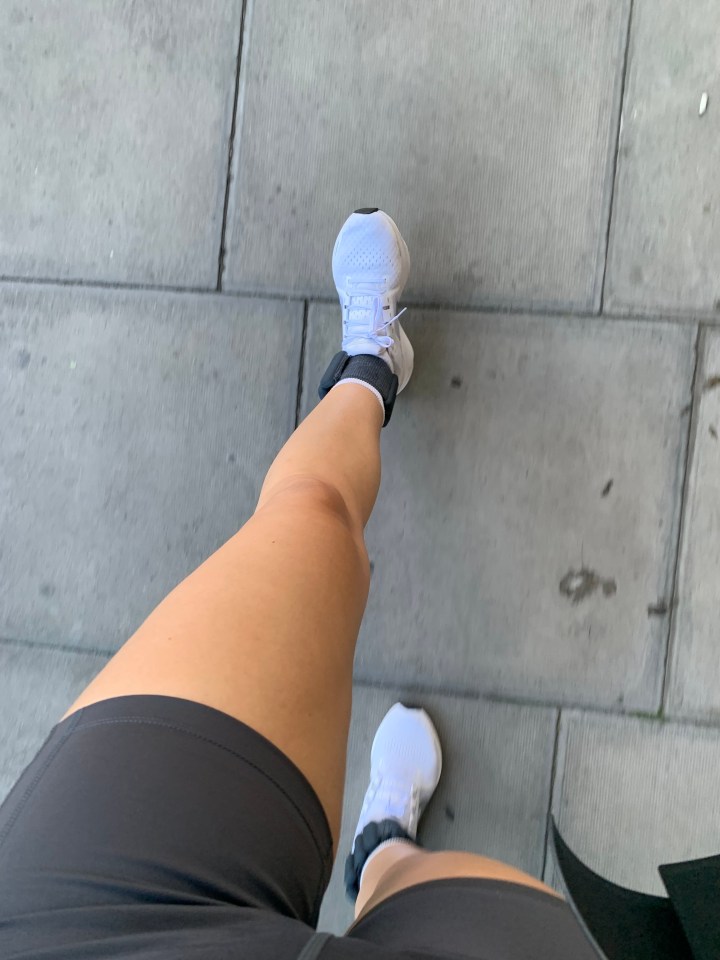 a person wearing a pair of white nike shoes