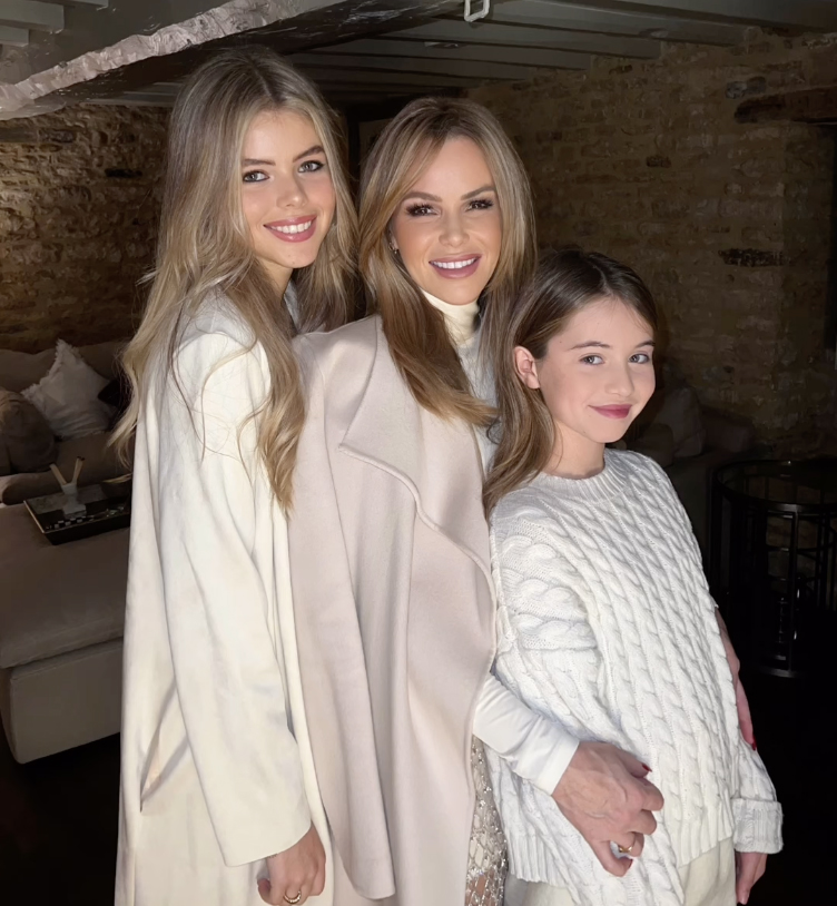 a mother and two daughters pose for a picture together