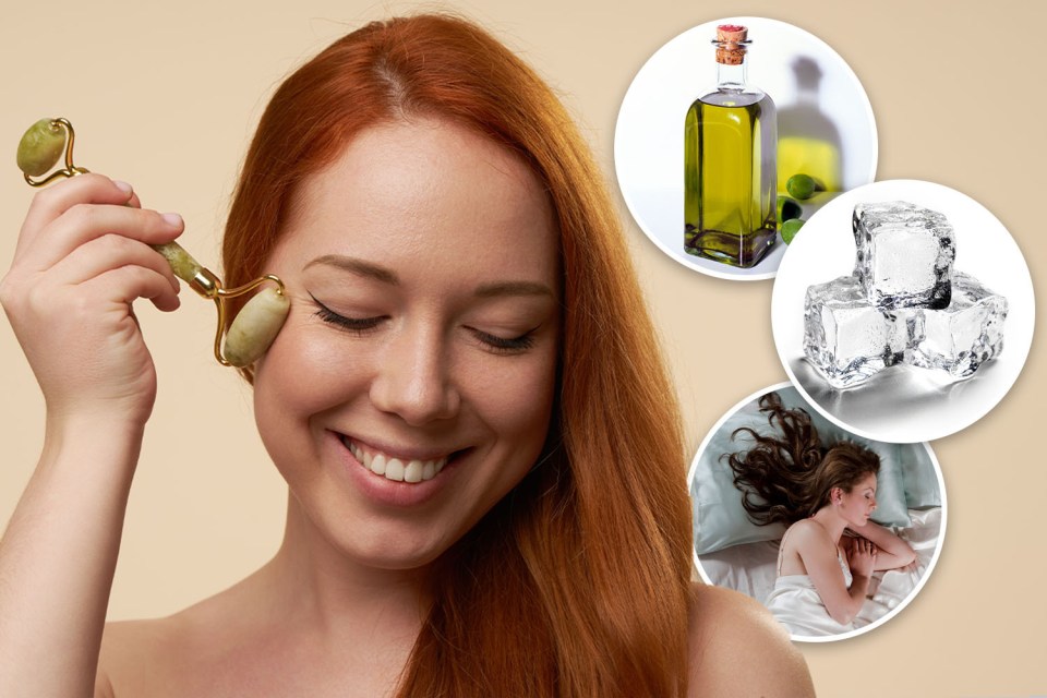a woman is smiling while using a roller on her face