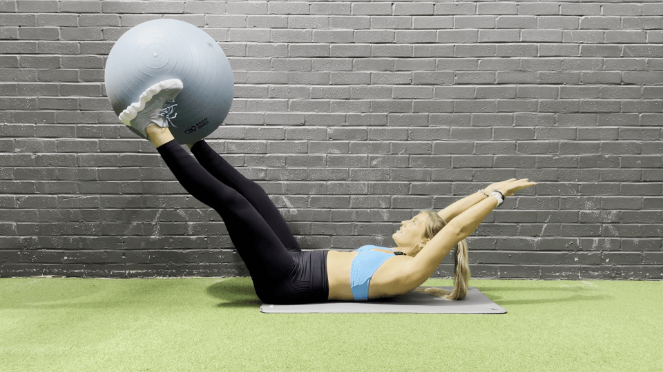 a woman is doing exercises with a pilates ball