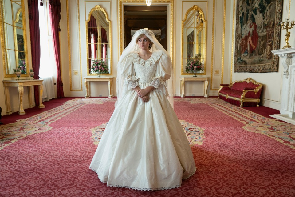 a woman in a wedding dress is standing in a room
