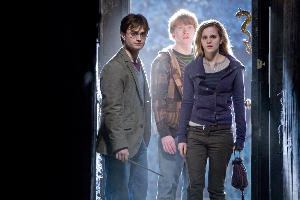 harry potter and his friends are standing in a doorway