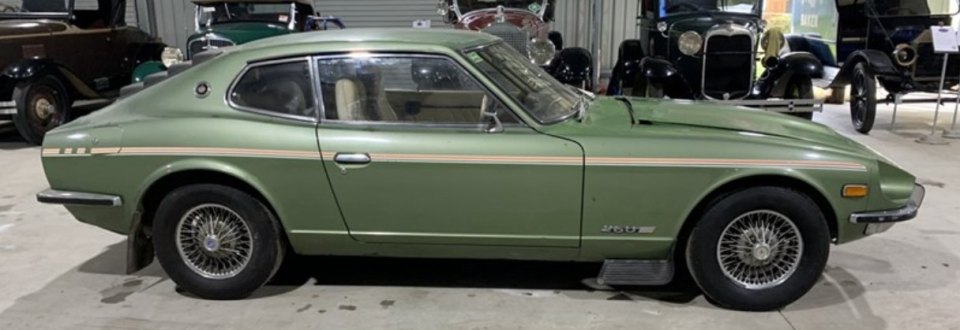 a green sports car is parked in a garage