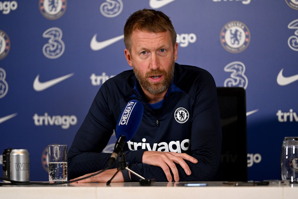 a man sitting at a table with a microphone that says chelsea tv on it