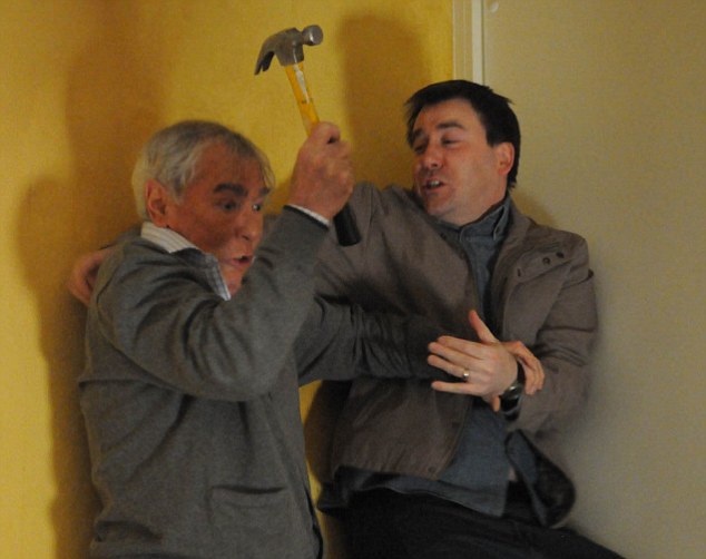 a man is holding a hammer while another man holds his arm around him