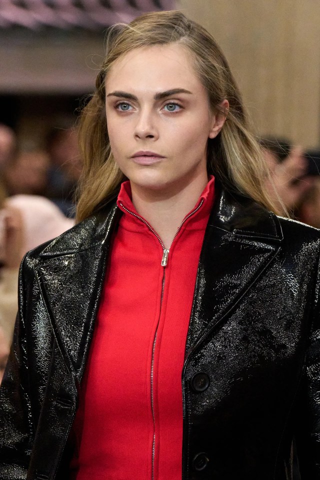 a woman with blonde hair and blue eyes looks at the camera