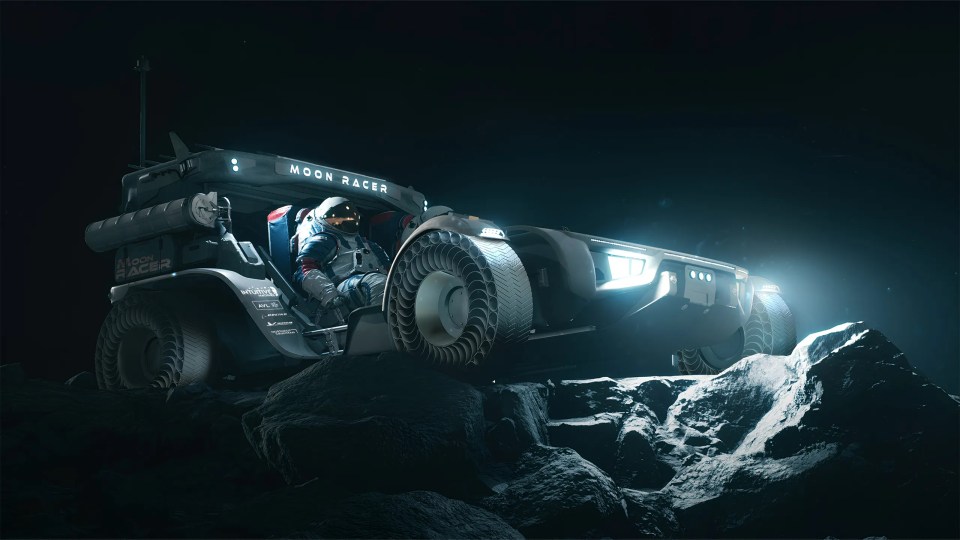 a man is sitting in a moon racer vehicle