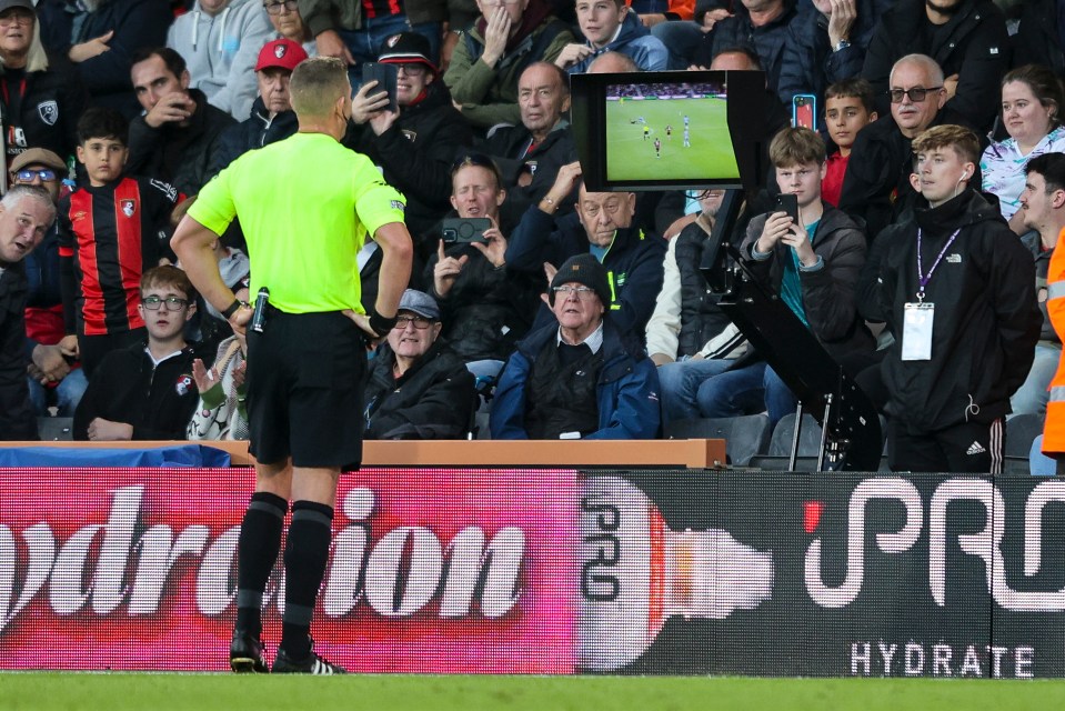 a referee stands in front of a sign that says pro hydrate