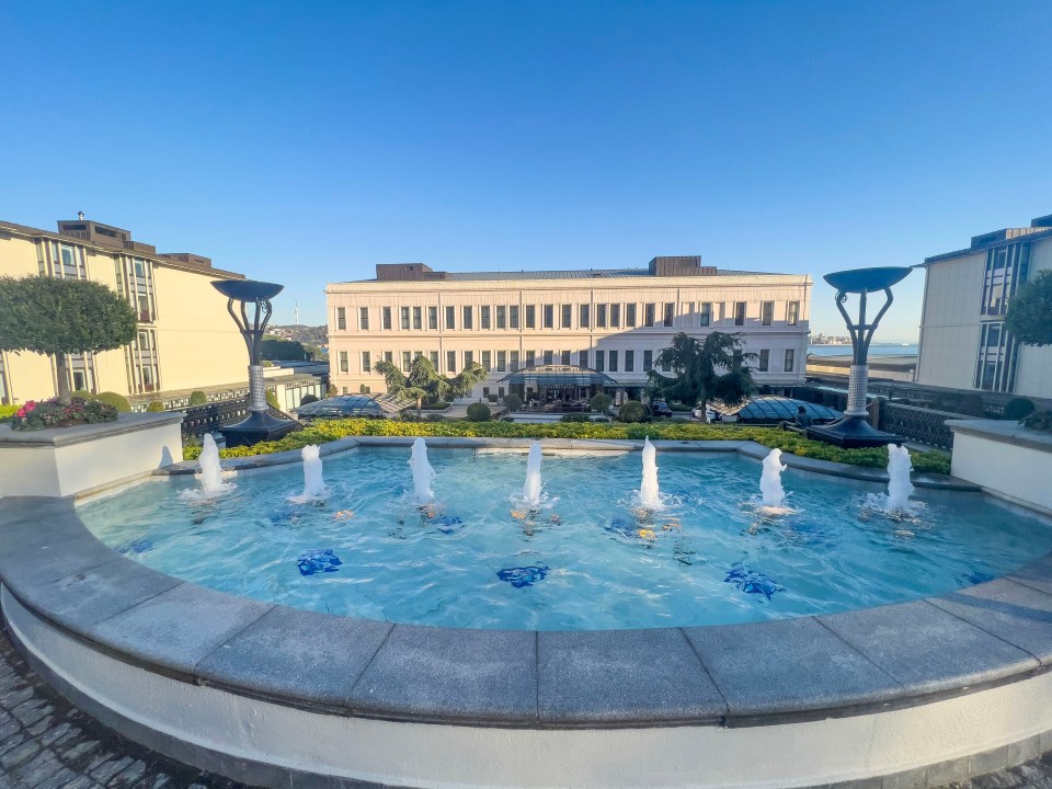 a large building with a fountain in front of it