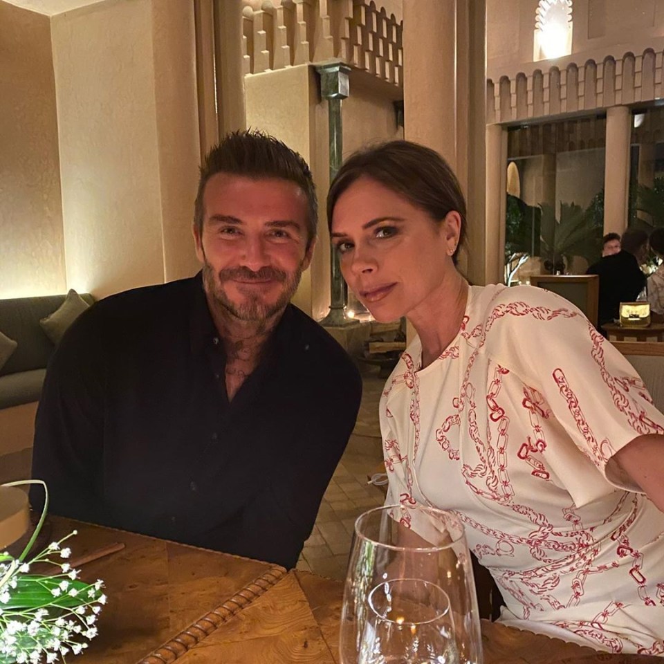 a man and a woman sit at a table with wine glasses
