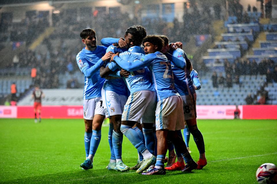 a group of soccer players are huddled together on the field