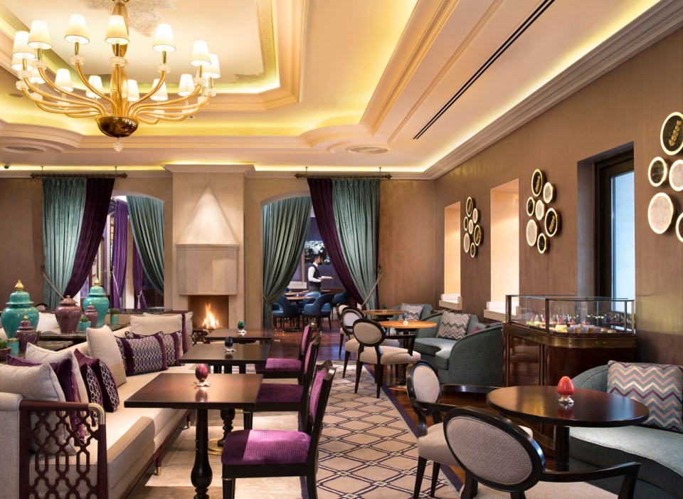 a restaurant with tables and chairs and a fireplace