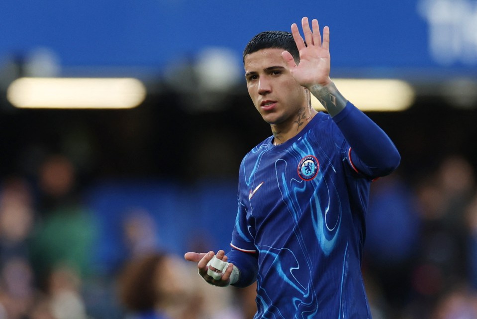 a soccer player wearing a blue shirt with the chelsea logo on it