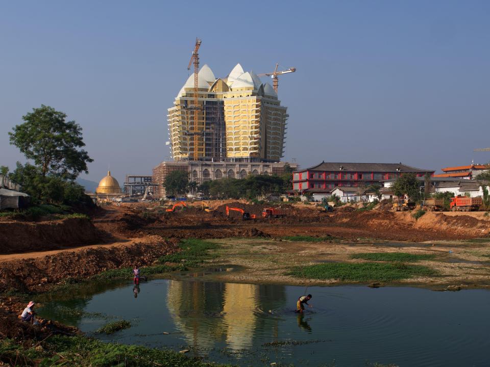 a construction site with a large building in the background