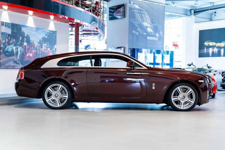 a rolls royce car is parked in a showroom