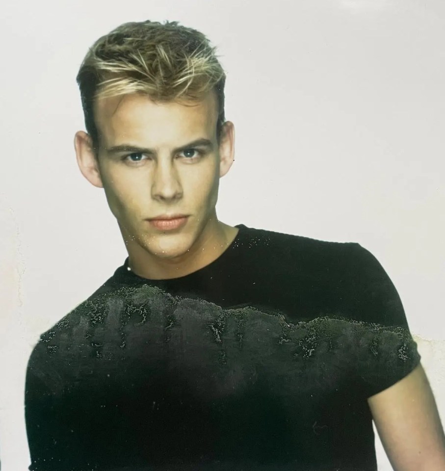 a young man with blonde hair is wearing a black shirt