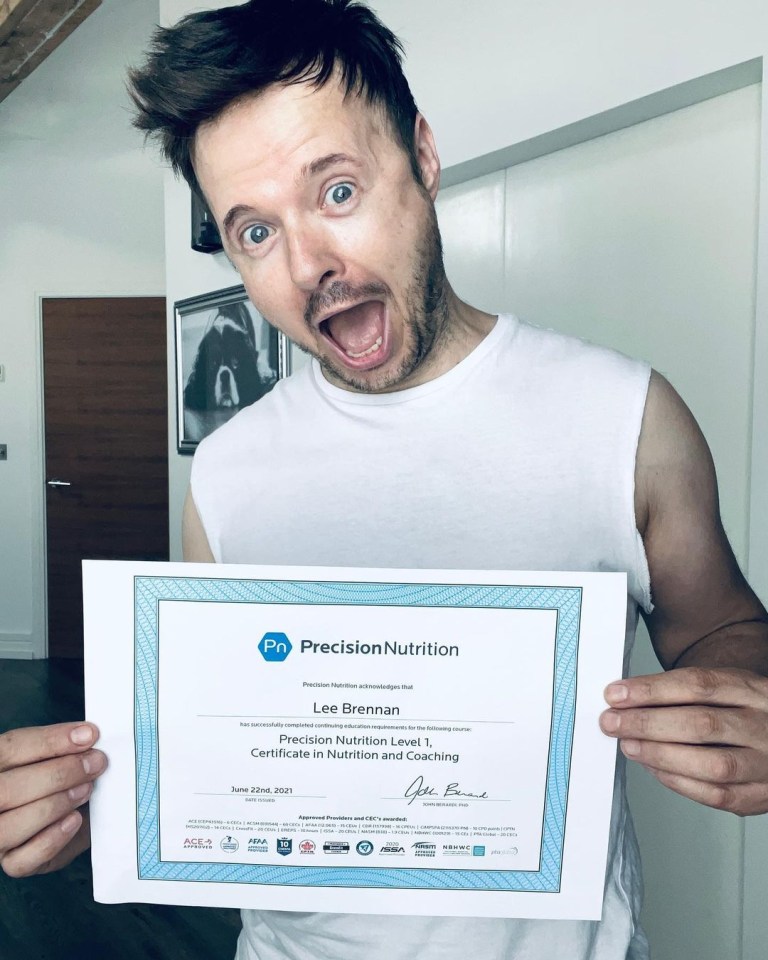 a man is holding up a precision nutrition certificate