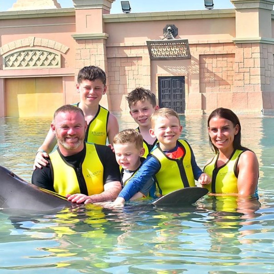 a family posing for a picture in the water wearing atlantic life vests