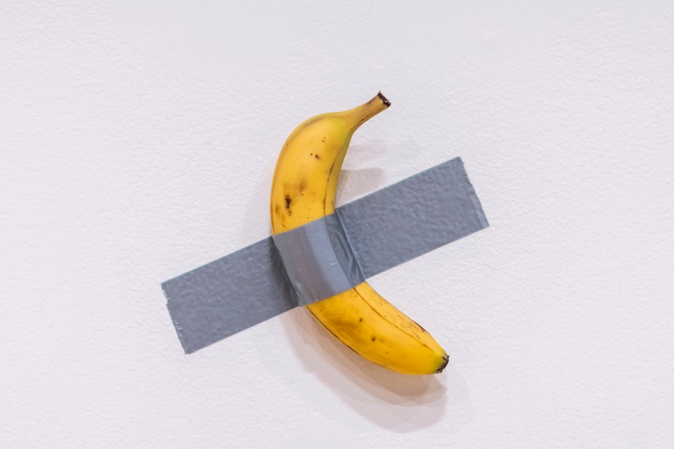 a banana is taped to a wall with duct tape