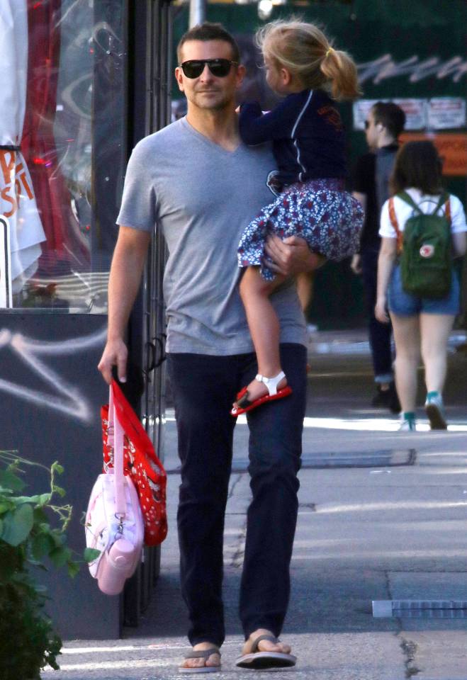 a man is holding a little girl in his arms