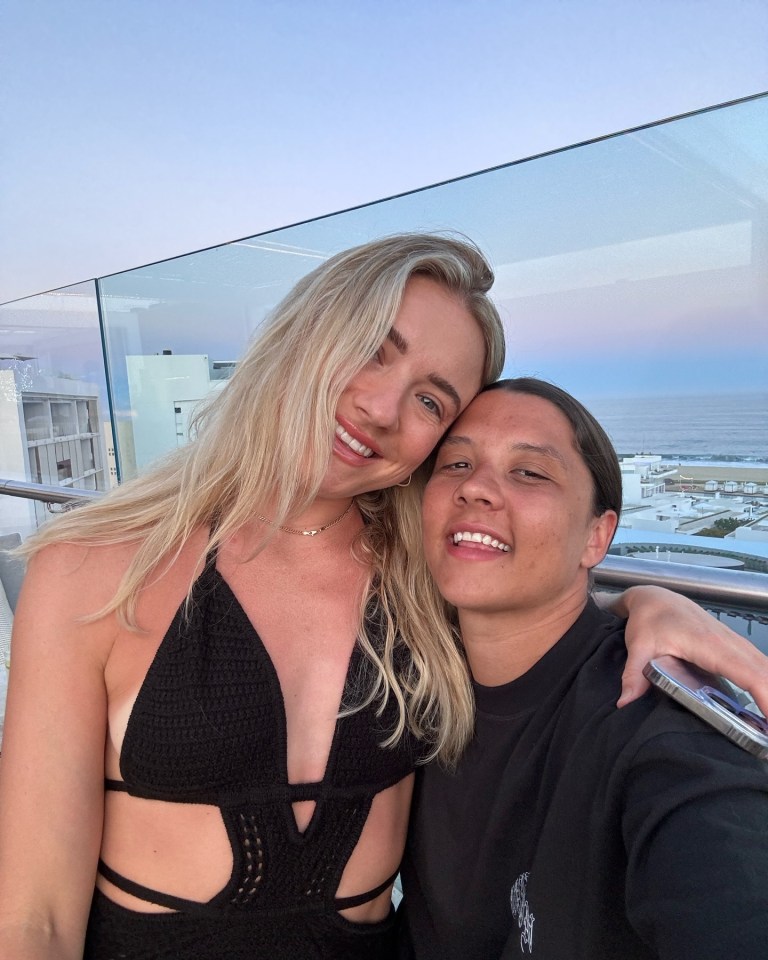 two women are posing for a picture and one is wearing a black shirt