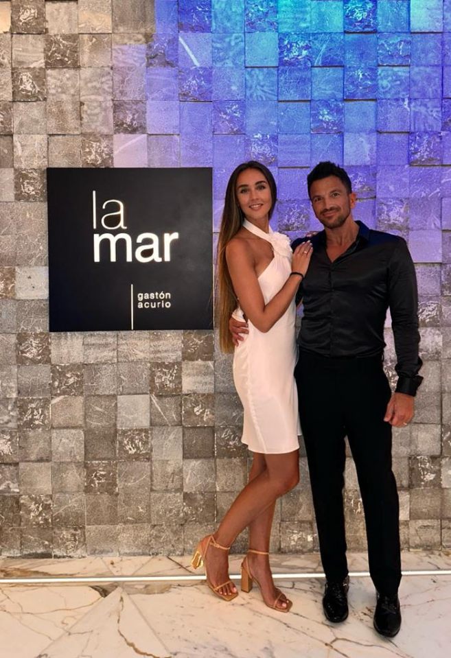 a man and woman pose in front of a sign that says la mar