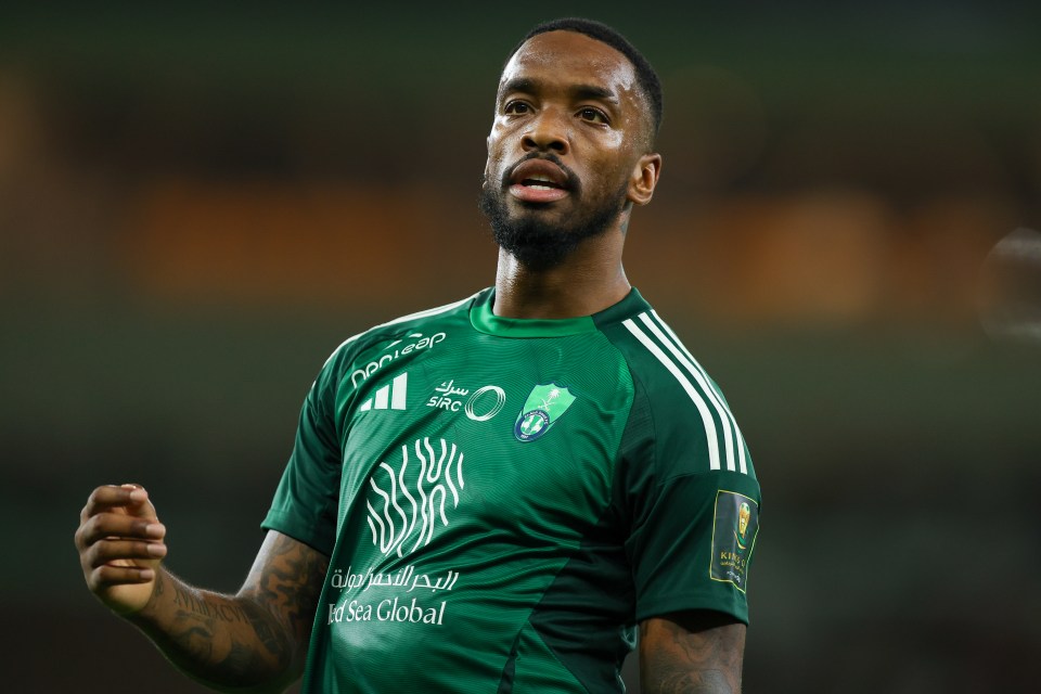 a man wearing a green shirt that says ' saudi sea global ' on it
