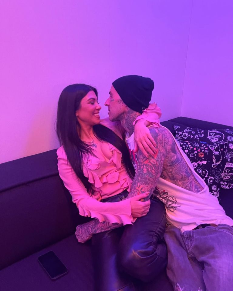 a man and a woman are sitting on a couch looking at each other